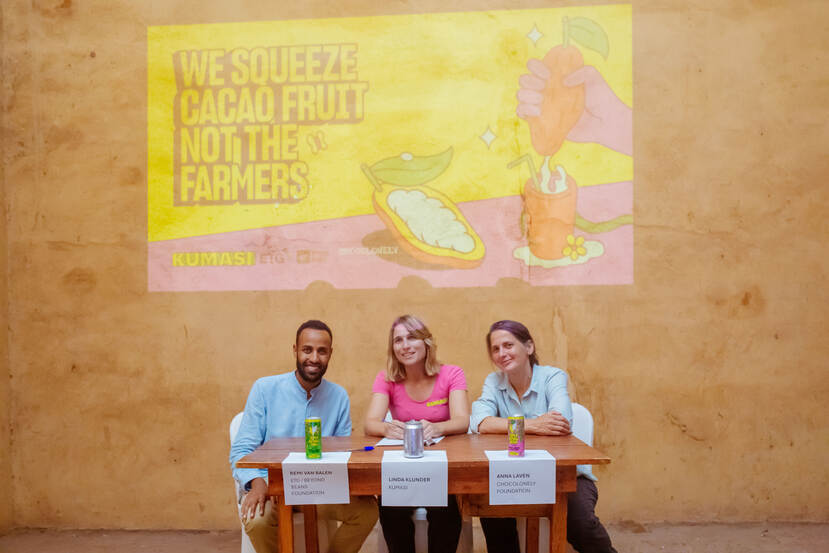 representatives from ETG/Beyond Beans, Kumasi and Chocolonely Foundation sitting together at a table with cans in front of them