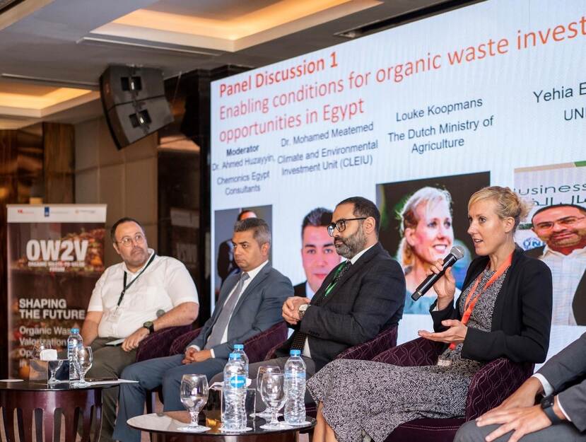 Louke Koopmans and representatives from Gov and private sector sitting on chairs in front of a presentation screen during the Waste to Value Forum