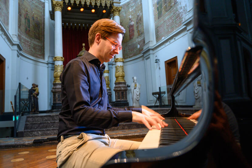 foto van Gwylim Janssens ahcter de piano in een kerk