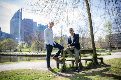 Sanjay en Daniël bij Koekamp in Den Haag met overheidsgebouwen op de achtergrond