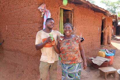 Cocoa farmers proudly showing a can with Kumasi juice