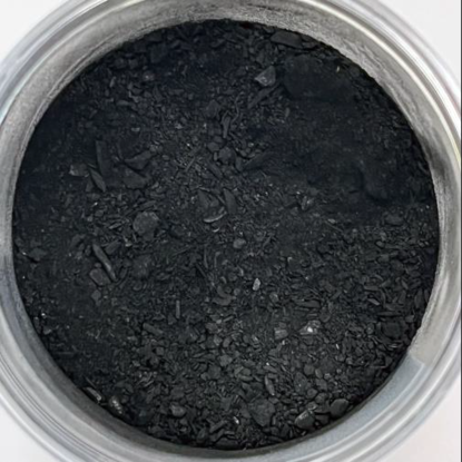 a closeup of a glass dish filled with biochar